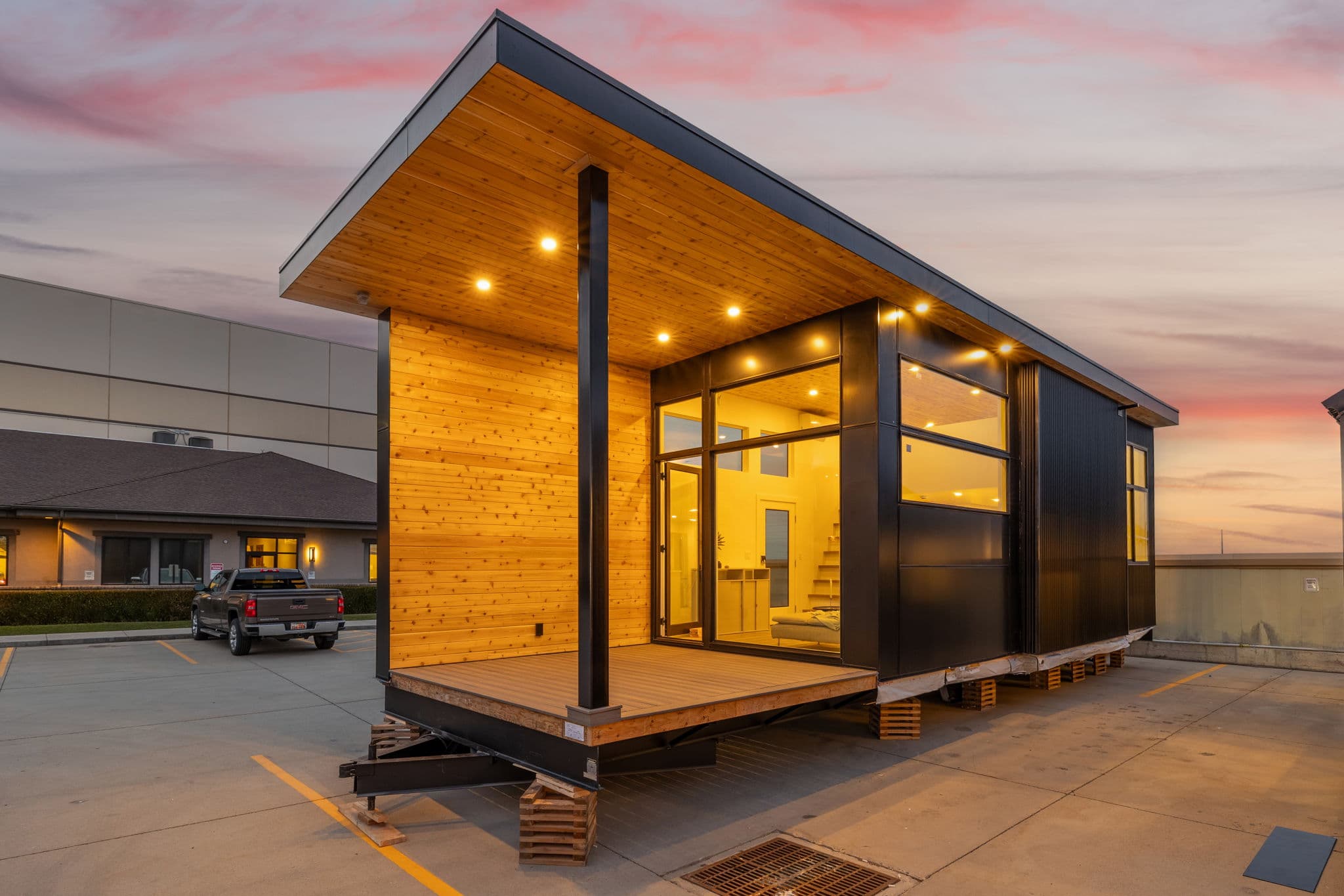 Skyview 400 park-model cabin in warm cedar and black, glowing at sunset